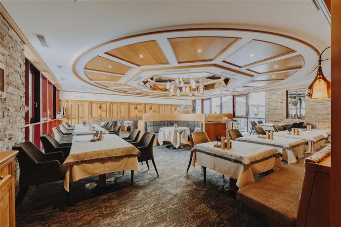 A stylish restaurant with elegant furnishings and an inviting atmosphere. The space is brightly lit and has a modern decor.