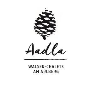 Ein stilisiertes Logo mit einer Tannenzapfen-Grafik. Darunter steht "Walser-Chalets am Arlberg".
