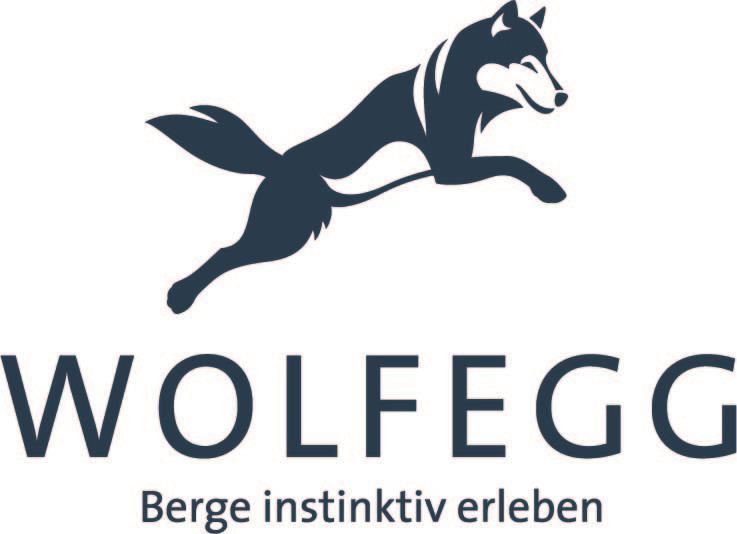 A stylized wolf leaps over the lettering "WOLFEGG". Below it is the slogan "Experience mountains instinctively".